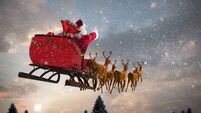Santa Claus riding on sleigh with gift box