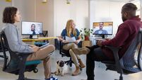 Entrepreneurs having hybrid meeting at startup office