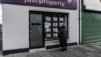 A woman studying property for sale/rent