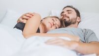 Couple sleeping and hugging happy in white bed