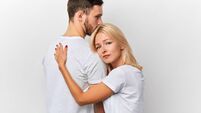 emotional young woman taking leave of her boyfriend