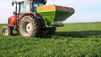 tractor fertilizing in field