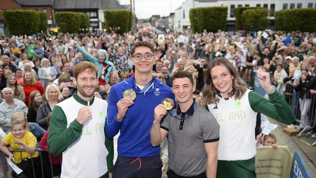 Irish international hockey player Michael Robson, Olympic gold medallists Jack McMillan, who won gold for TeamGB in swimming, and Rhys McClenaghan, who won gold for Ireland in gymnastics and runner Rachel McCann during a homecoming celebration in Newtownards, Co Down (Mark Marlow/PA)