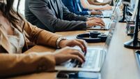 Close Up Photo of Business People Hands Using Laptop Computers in Open Plan Office