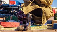 Snake charmer plays music for his cobra at the Jemaa el-Fnaa square in Marrakesh