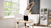 Businesswoman Stretching At Desk