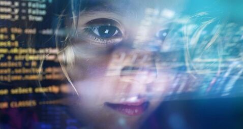 Close up of a little girl looking at some futuristic holograms.