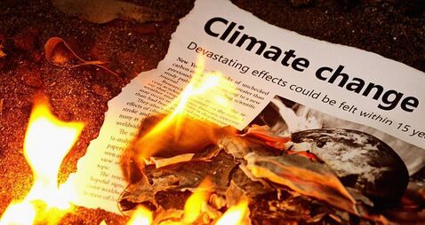 "Climate change" headline in flaming newspaper
