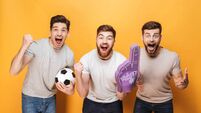 Three young cheery men football fans celebrating