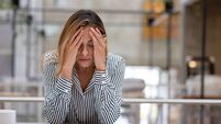 Stressed business woman having a headache at the office