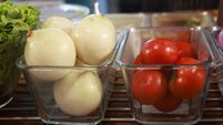 Assorted Vegetables in a Clear Box. A clear box filled with a variety of fresh vegetables such as mustard greens, broccoli, toma
