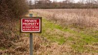 red wooden private property sign farm land no right of way no public access