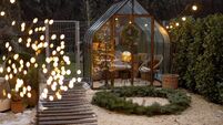 Beautiful backyard with vintage glasshouse and Christmas wreath on winter
