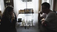 Father and daughter  playing chess