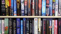 Second hand paperback books on shelves in a shop in Chapel St Leonards, Lincolnshire