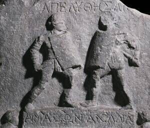 Two female gladiators in a scene captured in a second-century AD marble sculpture. Two female gladiators in a scene captured in a second-century AD marble sculpture.
