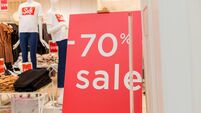 Sale up to 70 percent red sign. Red display with sale up to seventy percent inscription sticked on the store window.Seasonal dis