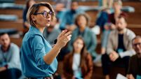 Female speaker giving a presentation during business seminar at convention center.