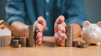 Divorce law and inheritance separation concept. Hand separate saving money, finance, home loan, debt return with piggybank and w