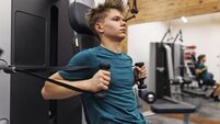 Teenage boy exercising in a gym