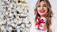 Beautiful girl sitting in a cozy atmosphere near the Christmas tree