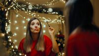Woman Using Mascara Applying Party Make-up for Christmas