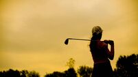 Silhouette of a female golf player