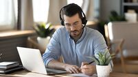 Focused,Young,Businessman,In,Eyeglasses,Wearing,Wireless,Headset,With,Microphone,