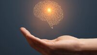 Artificial intelligence circuit board brain symbol on hand